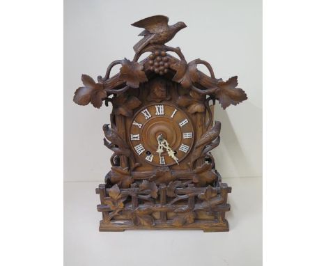 An unusual Cuckoo carved mantle clock, 46cm tall, in generally good condition, running order, small loss to minute hand 