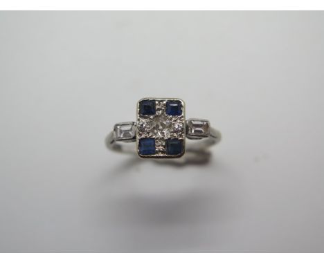 A sapphire and diamond tablet cluster ring, grain settings, diamond shoulders mounted in white, stamped 18ct PT, size M, weig