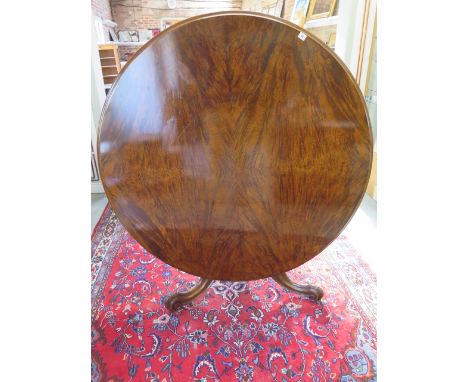 A Victorian walnut tilt top breakfast / dining table on carved tripod base, 72cm tall x 133cm diameter, in good condition and