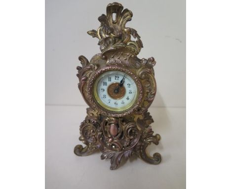 An Ansonia metal mantle clock with gilding, 8 day movement, ceramic 2" dial, working in good condition, 21cm tall 