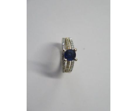 An 18ct gold ring, size M, with .52 diamonds and tanzanite or sapphire, marked 750, approx 6.4 grams, in good condition 