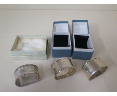 A pair of silver napkin rings and a single napkin ring, total approx 1.4 troy oz, all boxed in good condition 