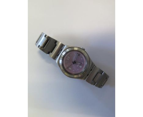 A ladies pink dial and stainless steel Swatch watch, in good condition 