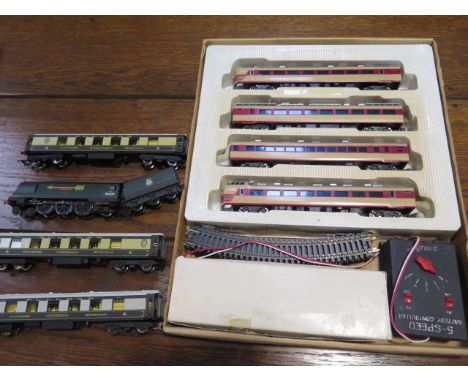 A Playart HO scale boxed train set and an unboxed Hornby 00 gauge Golden Arrow bocastle loco tender and 3 coaches 