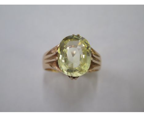A yellow gold ring set with a single citrine, approx 15 x 11 x 7mm, size V, approx 7.1 grams, not hallmarked but tests to app