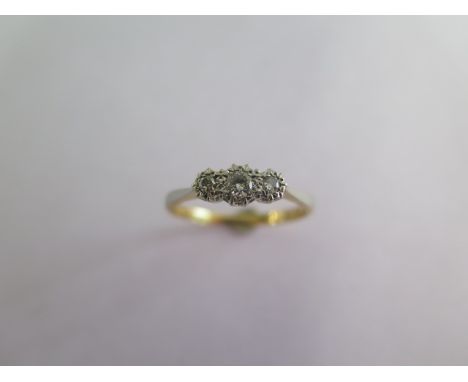 An 18ct platinum three stone diamond illusion set, ring size Q, approx 2.6 grams, generally good condition 