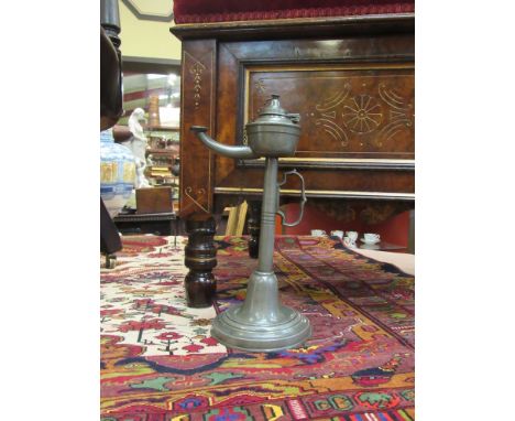 A Georgian pewter oil lamp with integral handle, circular stem to folded circular footed base 29cm tall 