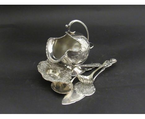 A silver plate sugar scuttle and associated flatware 