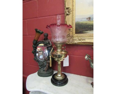 A Victorian oil lamp with a brass reeded column and brass font, complete with acid etched and cranberry Victorian shade and c