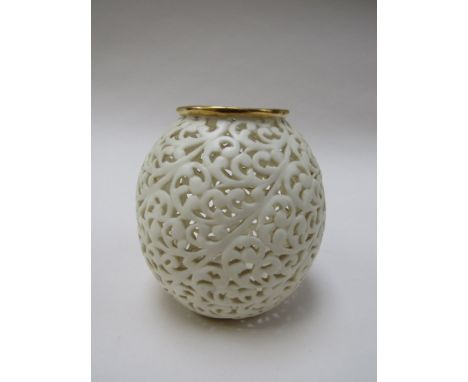 A Royal Worcester pierced ceramic tealight holder with gilt rim, 8.5cm tall