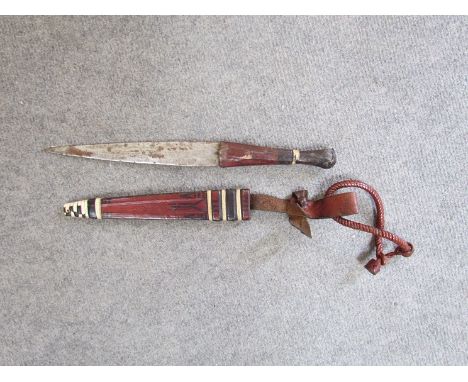 An African arm dagger with leather scabbard 