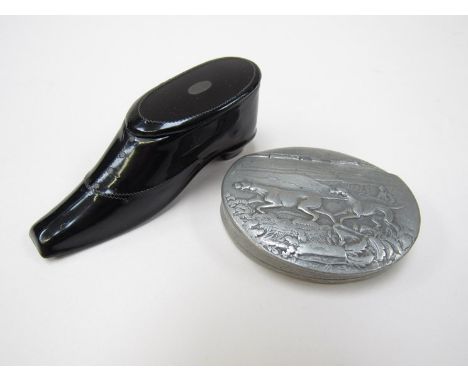 A Sheffield pewter snuff box with scenes of hunting dogs and handler and a black lacquered "shoe" vesta with striker sole (2)