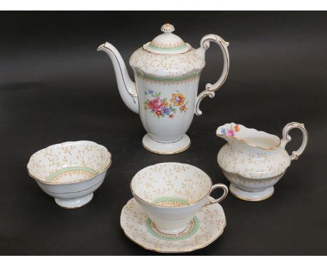 A Paragon china coffee set, cream ground with gilt, green and floral design