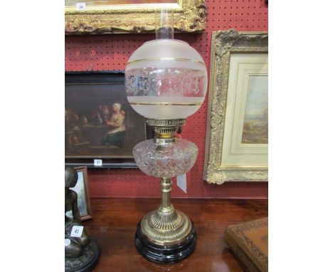 A Victorian oil lamp with a fine quality deep cut lead crystal font, brass reeded column and base complete with shade and chi
