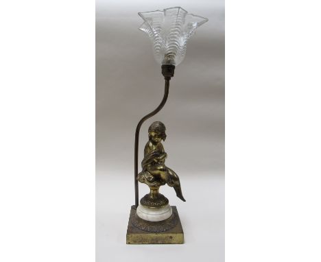 A gilt figural lamp of seated girl with clear glass shade, 49cm tall