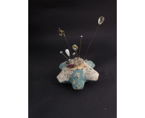 A pin cushion with a selection of hat pins 