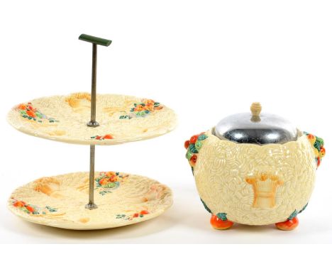 CLARICE CLIFF.&nbsp; AN A J WILKINSON CELTIC HARVEST CAKE STAND WITH GREEN BAKELITE TYPE 'T' HANDLE, 25CM H AND A SIMILAR CON