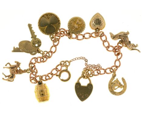 A 9CT GOLD CHARM BRACELET, 18G  ONE CHARM UNMARKED. LIGHT SURFACE WEAR CONSISTENT WITH AGE AND USE