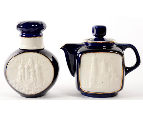 &nbsp;A RUSSIAN COBALT GROUND PORCELAIN TEAPOT AND COVER AND TEA CADDY AND COVER, EACH WITH M0ULDED BISCUIT PANELS, 14CM H, 2