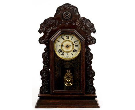 AN ANSONIA CARVED AND STAINED SOFTWOOD SHELF CLOCK WITH GILT GLASS DIAL, GONG STRIKING MOVEMENT AND BRASS PENDULUM, GOB 58CM 