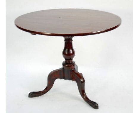 A GEORGE III MAHOGANY TRIPOD TABLE, the tilting one-piece top above a baluster stem and cabriole tripod base, 36" (91.5cm) di