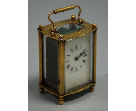 20th CENTURY FRENCH BRASS CASED CARRIAGE CLOCK of typical form with roman dial, oblong top, glass and ball feet (one pushed i