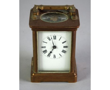SMALL BRASS CARRIAGE CLOCK, of typical form with oval top glass and shaped top handle, 4 3/4" (12cm) high 