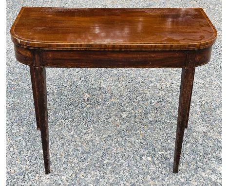 A late George III mahogany and crossbanded fold top card table, raised on square taper legs, height 72cm, width 91.5cm, depth