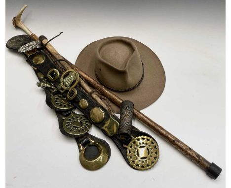 An Australian Akubra hat, together with other items including horse brasses, a whip and a horn handled stick.