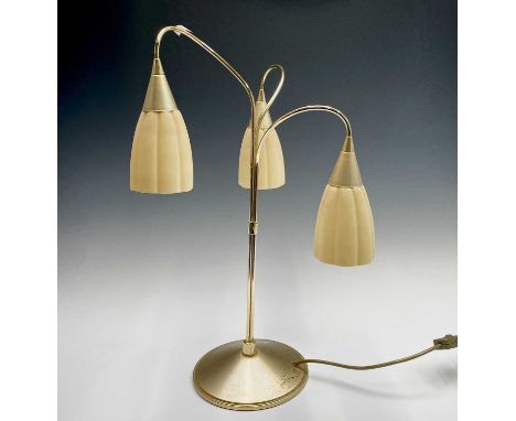 A mid century lacquered brass table lamp with three glass shades. Height 58cm.