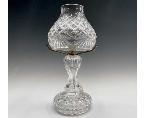 A Waterford crystal cut glass table lamp and shade, supported on three brass arms and baluster stem, height 42cm, diameter of