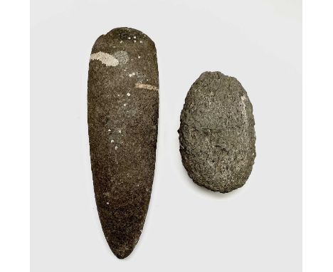 A Neolithic stone axe head, reputedly found in West Penwith, length 21cm, together with another textured stone implement (2).