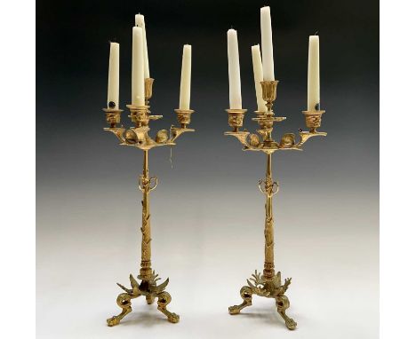 A pair of gilt metal ornate candelabra, probably French, circa 1890, each with a central sconce and three branches, with leaf