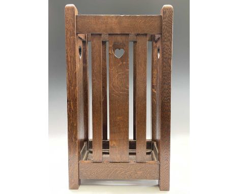 A Liberty &amp; Co Arts &amp; Crafts oak stick stand with heart cut-outs, and inset metal drip tray. Height 68.5cm, width 38c