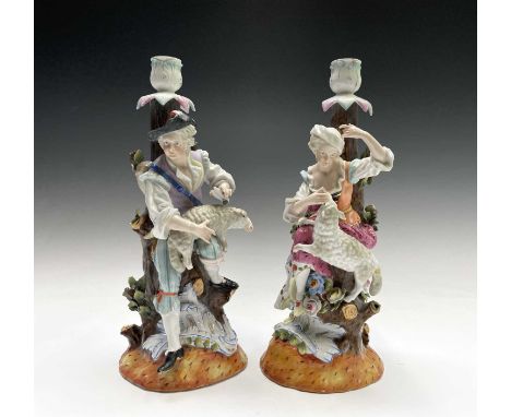A pair of Helena Wolfsohn porcelain candlestick figures, modelled as a shepherd and his companion wearing 18th century costum