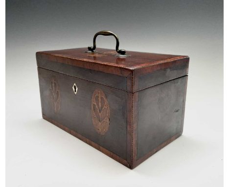 A George III mahogany and crossbanded tea caddy, with three floral inlaid oval panels, brass handle and triple divided interi
