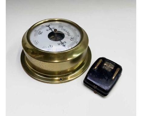 A vintage Ardente hearing aid, with tinned case, height 9cm, together with a brass cased aneroid barometer, diameter 19.5cm (