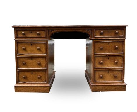 A Victorian oak desk, stamped Taylor, Fisher &amp; Blunt, 110 Fenchurch St, London, with eight pedestal drawers, height 78cm,