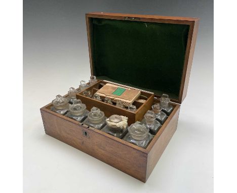 A Victorian oak cased family medicine chest, fitted with an assortment of glass jars and stoppers, lift-out section, scales, 