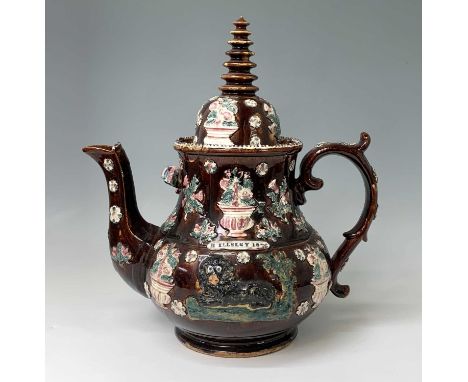 A Measham treacle glazed barge ware teapot, dated 1876, of large proportions, the domed cover with 'Stupa' style finial, appl