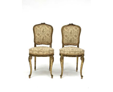 A Pair of 19th century French giltwood salon chairs with tapestry upholstered seats and backs, on carved cabriole front legs.