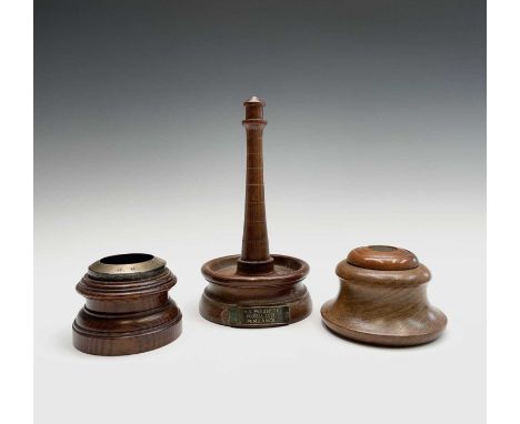 A turned teak lighthouse from the timber of HMS Warspite and labelled Prussia Cove, Penzance, height 21.5cm, together with an