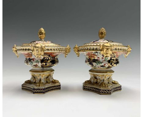 A pair of early 19th century Derby porcelain imari and gilt decorated pot pourri vases, of squat form, with pierced rims and 