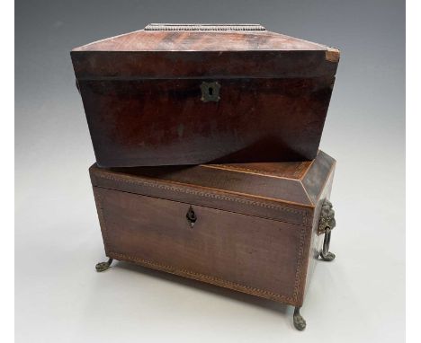 A George III mahogany, inlaid and chequer strung tea caddy, with fitted interior and brass lion mask handles on paw feet, wid