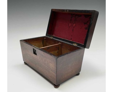 An early 19th century mahogany tea caddy, of sarcophagus shape, width 23cm.