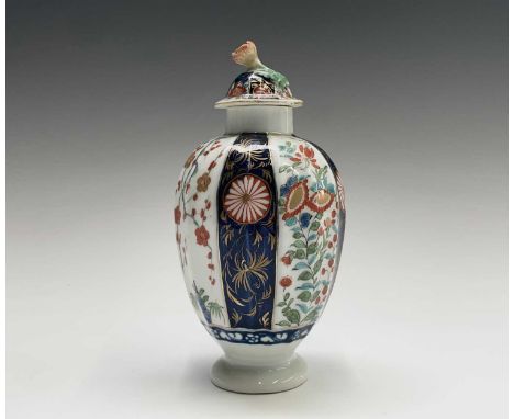 A Worcester porcelain tea caddy and cover, circa 1780, of fluted ovoid form, decorated with Kakiemon inspired panels divided 