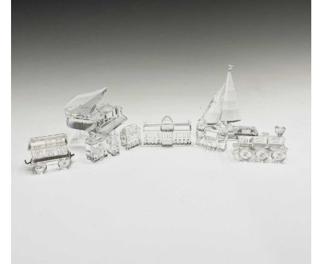 A collection of boxed Swarovski Crystal sculptures to include a grand piano, sailing boat, railway engine with a carriage, an
