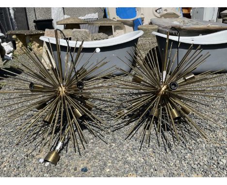 A pair of modern retro style light fittings, each with numerous spikes and fitted ten light branches, diameter 89cm.Condition