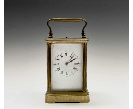 A French brass repeating carriage clock, circa 1900, with white enamel dial, striking on a coiled gong, height 13.5cm.Provena