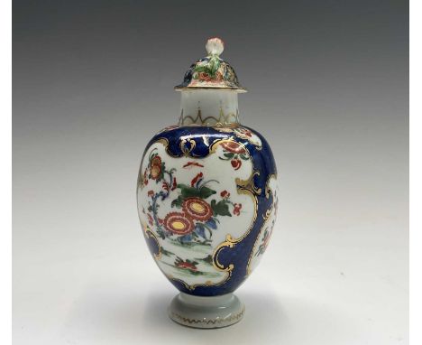 A Worcester tea caddy and a cover, circa 1770, the blue scale ground with panels of Japan flowers, blue seal mark, height 15c